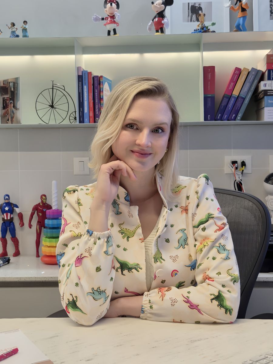 Dra Leticia Schwab sorrindo em seu consultório
